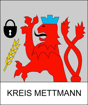 Ein roter Löwe mit blauer Krone, ein Schloss und eine Ähre. Darunter steht in Großbuchstaben "Kreis Mettmann".