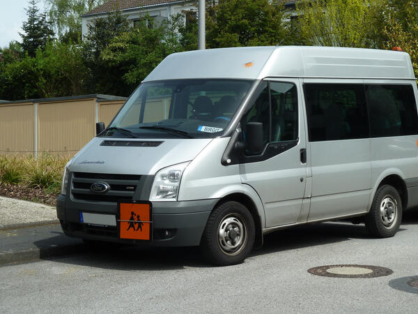 Bild vergrößern: Ein Personentransporter mit einem Hinweisschild fr Personenbefrderung.